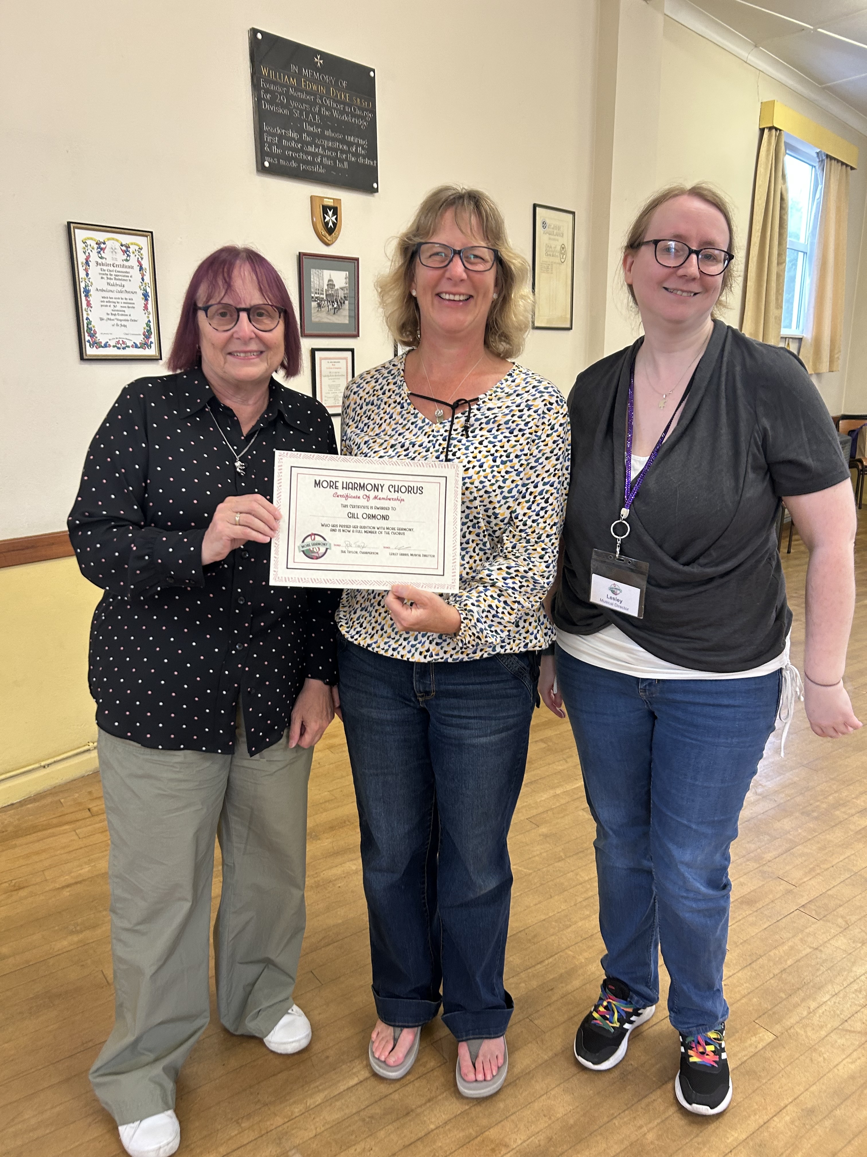 Gill receiving her More Harmony membership certificate from former LABBS Chair Sue Ransom and Musical Director Lesley-Anne Harris