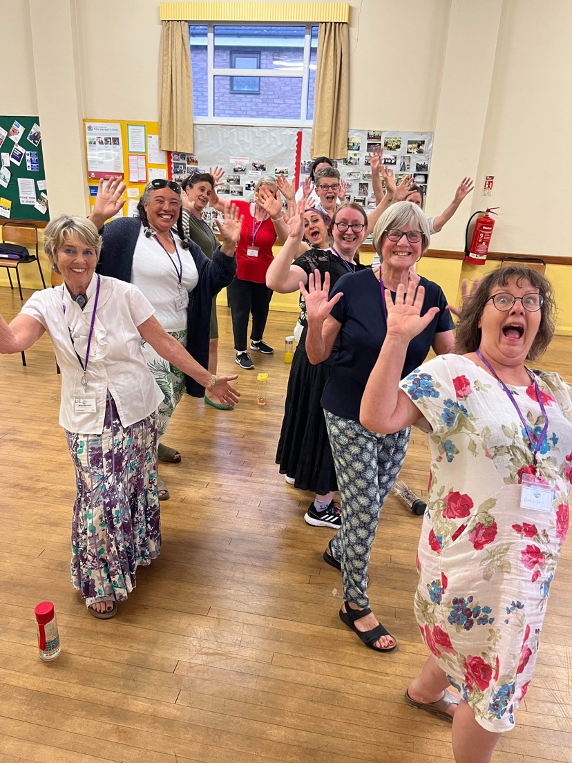 More Harmony, a women's choir based in Cornwall, doing jazz hands for the camera!